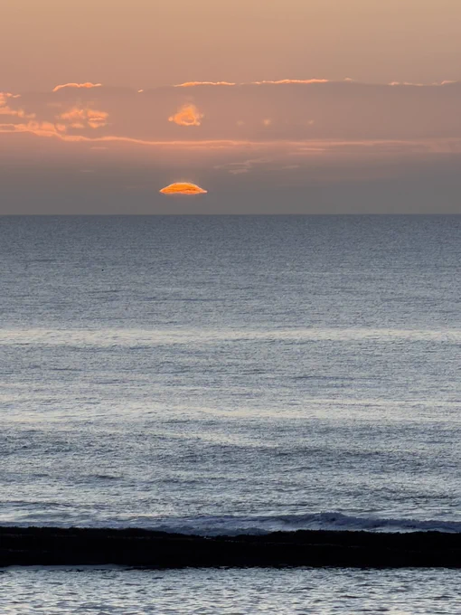 Clear sky and calm sea.