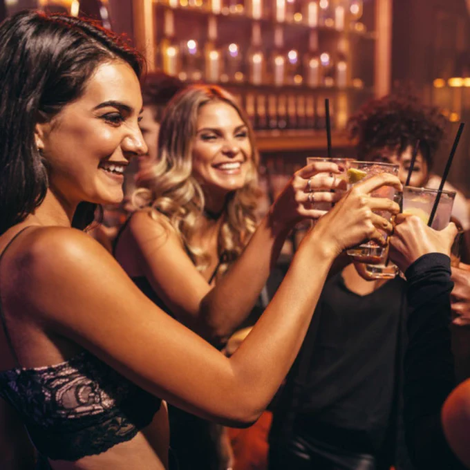 young women drinking at a bar