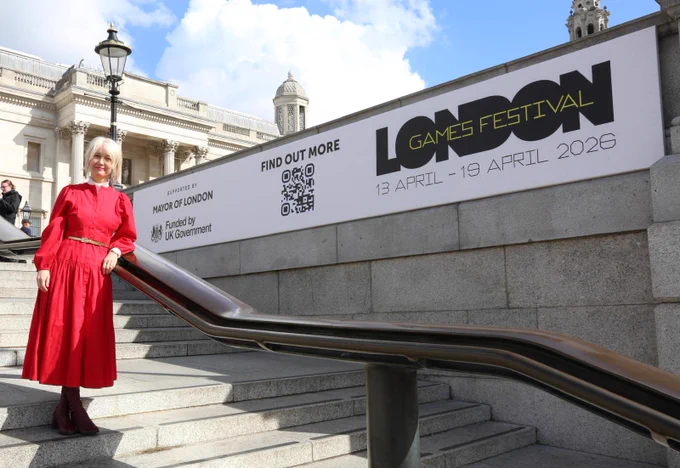 Deputy Mayor Justine Simons OBE stands on the steps in Trafalgar Square beside a large banner for the London Games Festival. The banner reads “LONDON Games Festival, 13 April – 19 April 2026,” with supporting logos for the Mayor of London and UK Government.