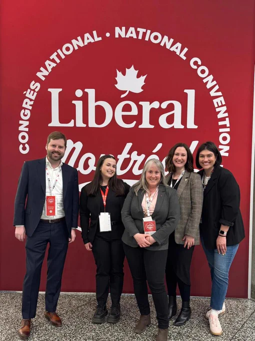 A group photo in front of the LPC signage. 