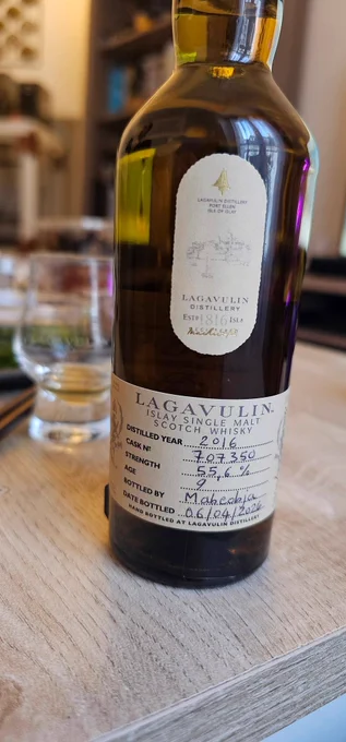 A small bottle of Lagavulin whisky with a few official stickers, one partially handwritten. It indicates the content was distilled in 2016, and bottled by me on april 6, 2026.