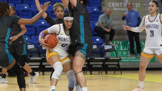 Esmeralda Enriquez drives through defenders with the ball in traffic. Photo credit: NJCAA