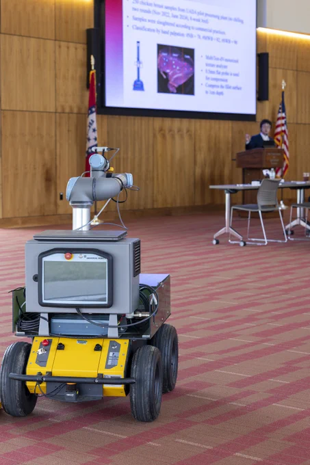 Roving robot on four wheels with robotic arm used.