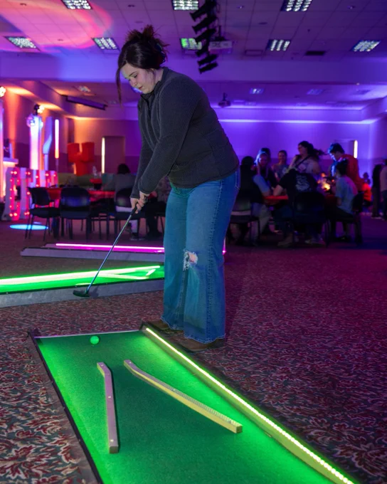 A student playing mini golf at this year's campus carnival. 