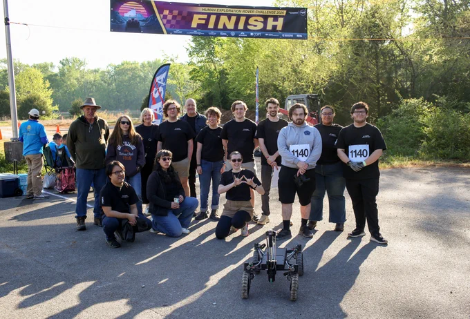 The HERC team poses at the finish line with the remote-controlled rover.