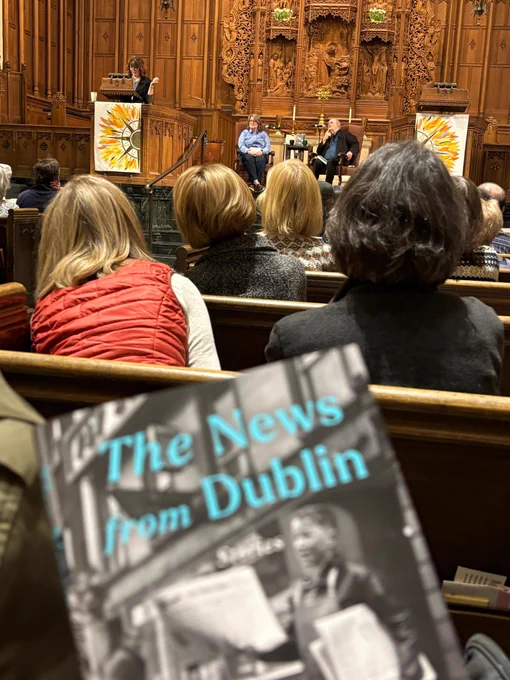 Photo taken at event, book cover in background