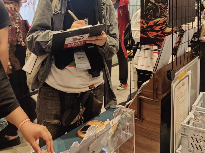 Signing petition at an artist alley in an anime convention 