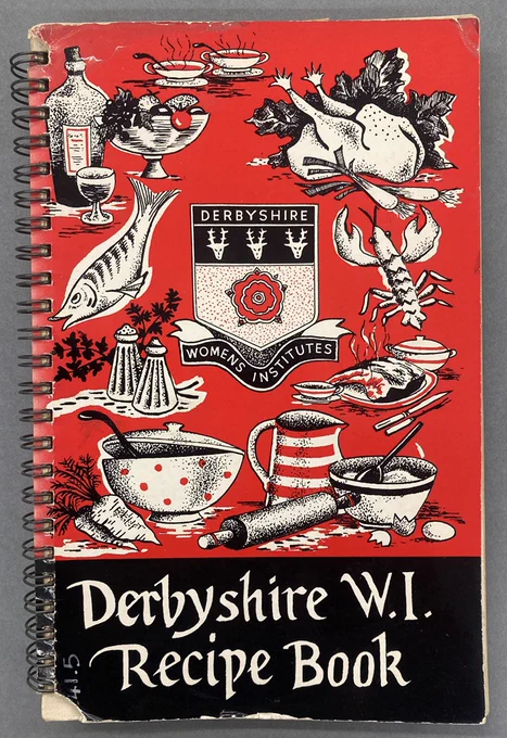 Front cover of the publication 'Derbyshire W.I. Recipe Book'. It shows drawings of a variety of foods and cooking equipment on a red background, with the Derbyshire Women's Institute logo in the centre.