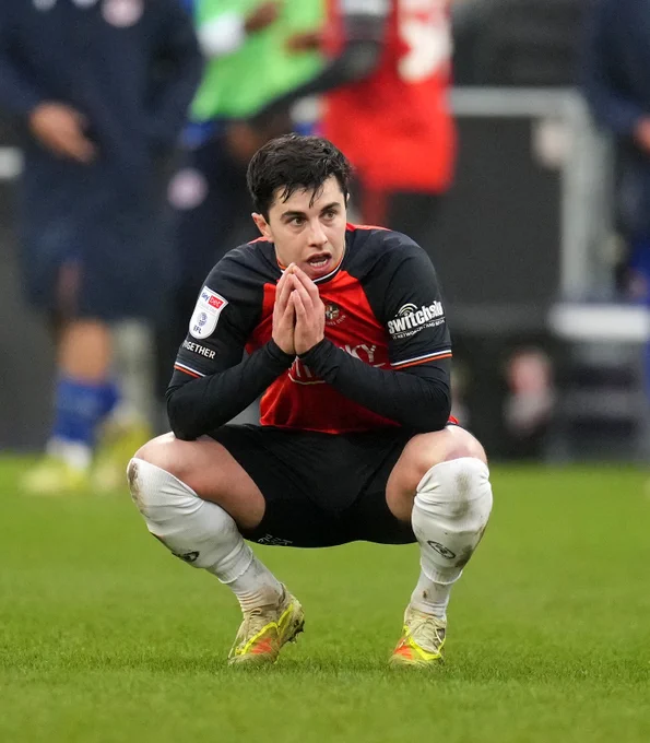 Liam Walsh crouched down on the Kenilworth Road turf after a 3-2 defeat to Reading.