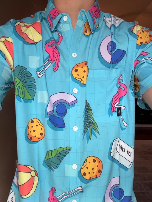 A bright blue button up shirt with the Clerk logo, flamingo, cookie, ship it keyboard, palms, beach balls