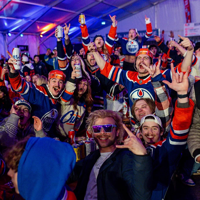 Oilers fans celebrate a goal inside the tent at ICE District's Fan Park