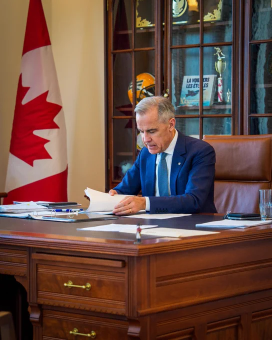 Prime Minister Carney works at his desk in Ottawa, Ontario.