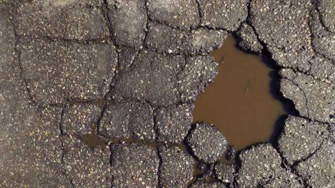 a pothole with water in it.