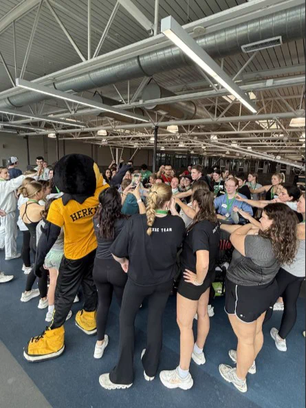 Hawkathlon participants huddle up with Herky.