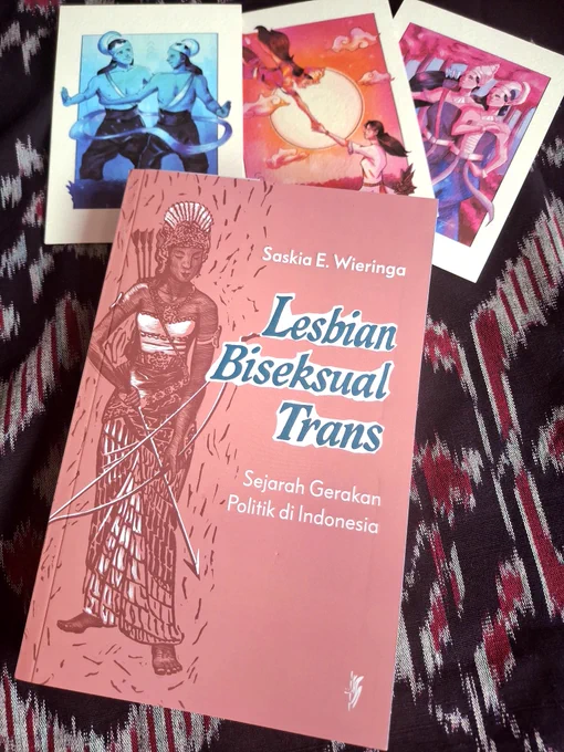 A photo of a book titled Lesbian, Biseksual, Trans: Sejarah Gerakan Politik di Indonesia. The book cover is pink with the image of a Javanese wayang orang figure in the form of a woman holding a bow and arrow.
