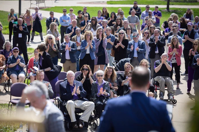State Sen. Melissa Ratcliff, State Rep. Brienne Brown, and State Sen. Mark Spreitzer applaud from the crowd.