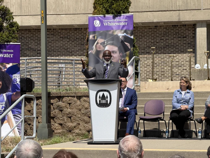 UW-Whitewater Chancellor Corey King speaks from a podium.