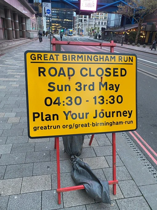 Road sign says: Great Birmingham Run. Road Closed Sunday 3rd May 04.30 to 13.30. Plan your journey.