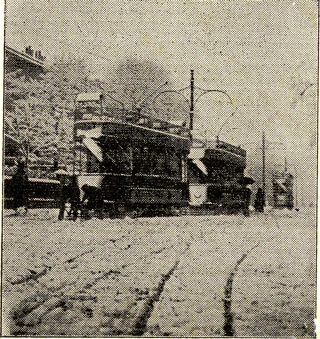 A black and white newspaper photo of tramcars in the snow
