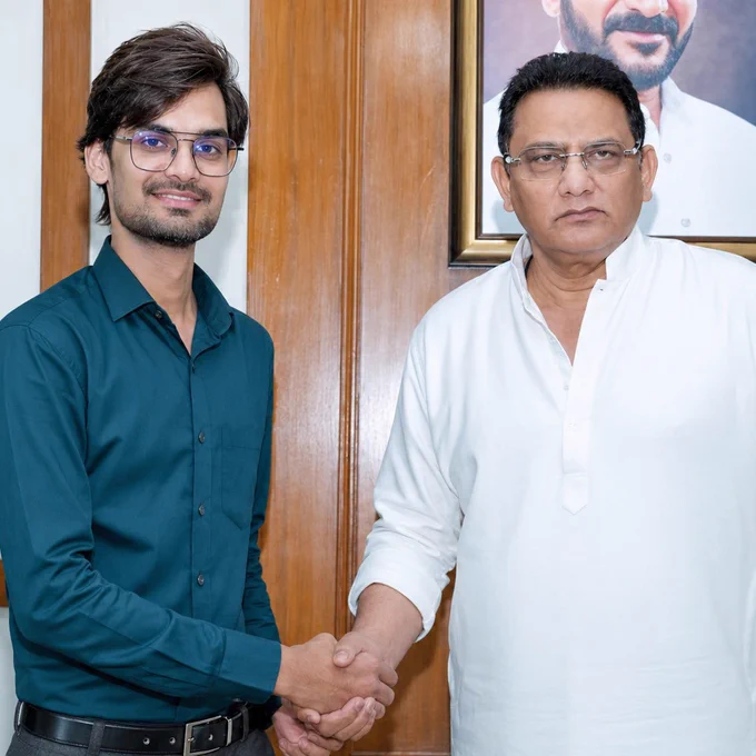 Aamer Ali Khan congratulating Mohammed Azharuddin, Hon’ble Minister for PE & MW, on his appointment as MLC, Telangana, during a formal meeting, with both individuals shaking hands in an official setting.