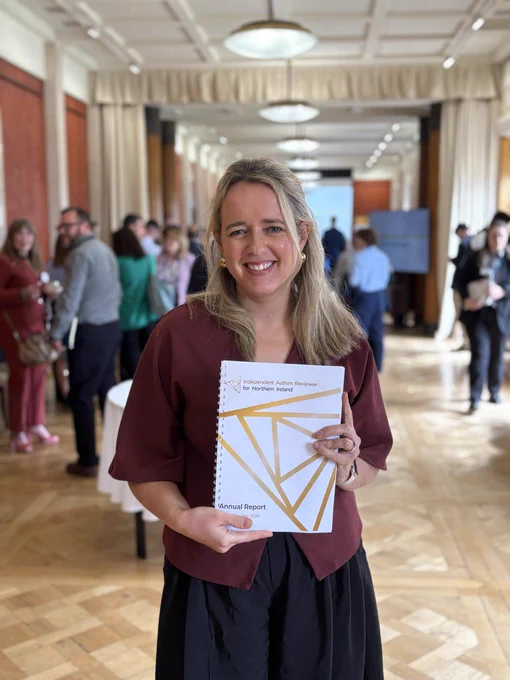 Me holding a copy of the report