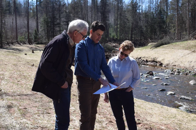 Gov. Evers looks at plans next to creek