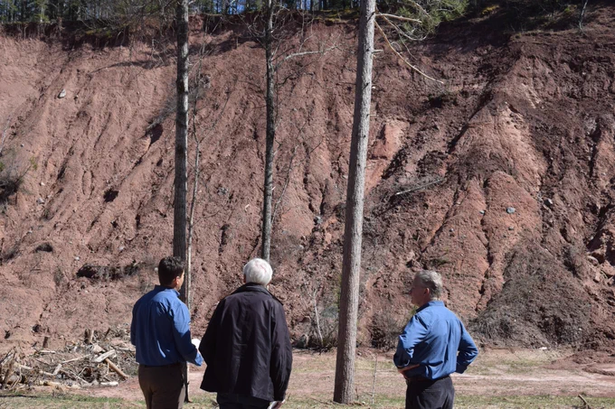 Gov. Evers looks at bare side of bluff