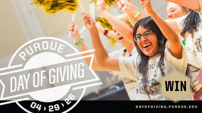 Purdue Day of Giving event with people cheering and waving pom-poms.
