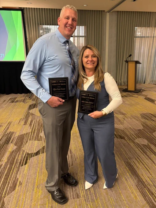 Lt. Dexter Howard and Amber Smith pose for a photo holding their plaques after winning the Excellence in Crisis Collaboration Award. 
