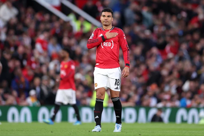Casemiro pats the United badge on his chest.