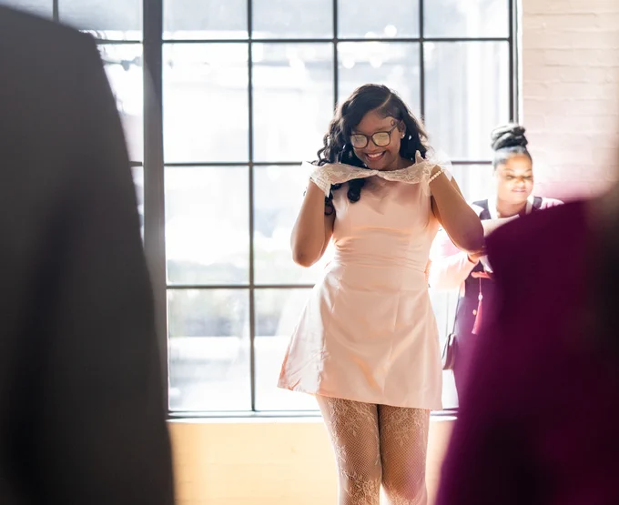 A student smiles and walks during the Ring Ceremony.