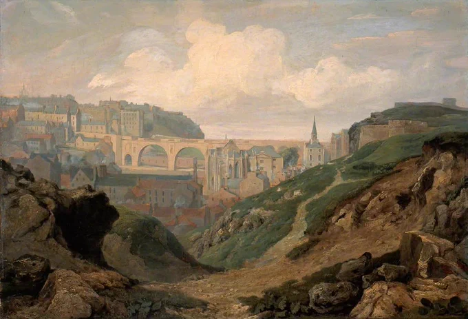 View of the city of Edinburgh, showing the castle on the hill , with the town spreading out below it towards the sea, under a cloudy sky.