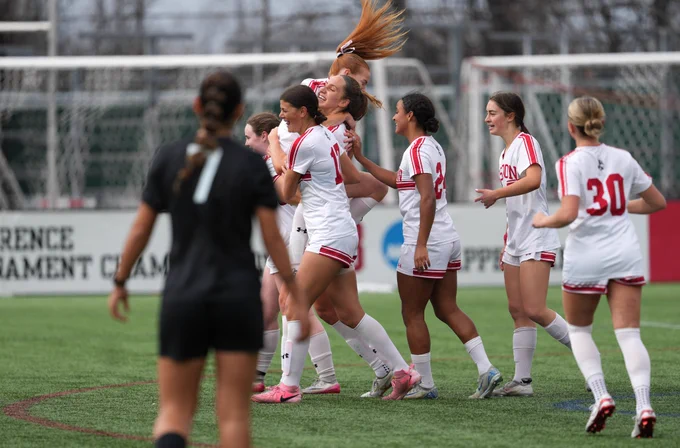 BU women's soccer celebrating a goal.