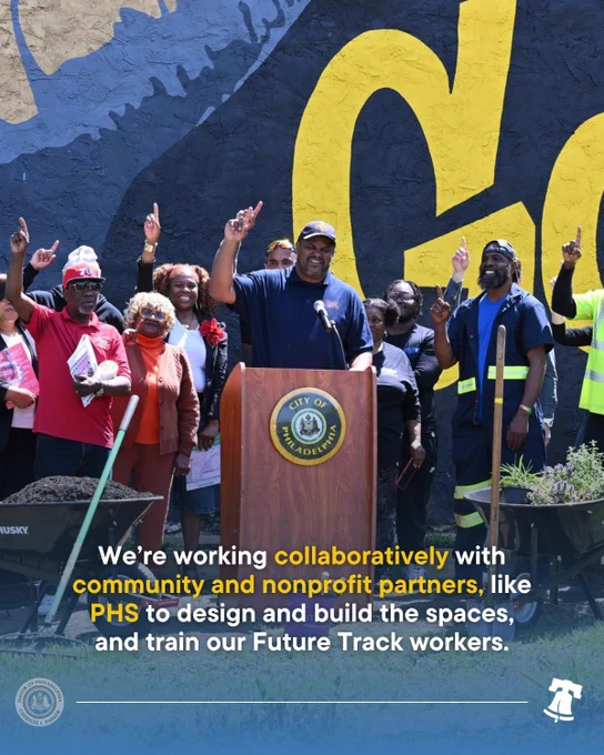 Office of Clean & Green Initiatives officials and workers smiling behind a podium.
