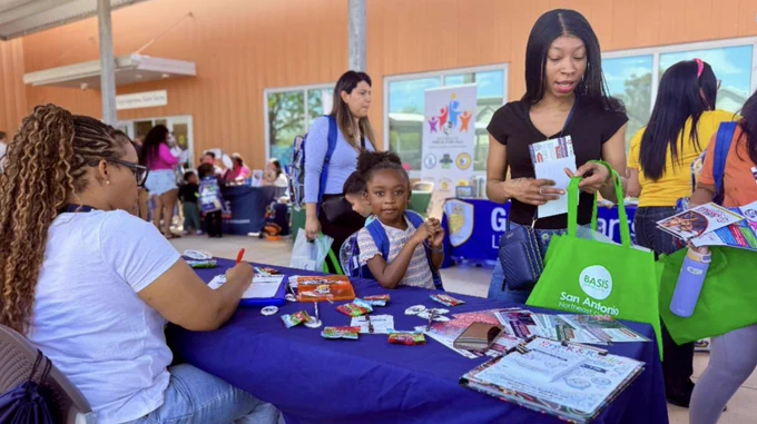A mother and daughter getting information at a table at Welcome to Kinder.