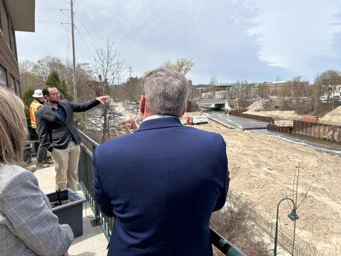Federal, state, local and tribal partners overlook Union Street Dam in Traverse City as part of a tour.
