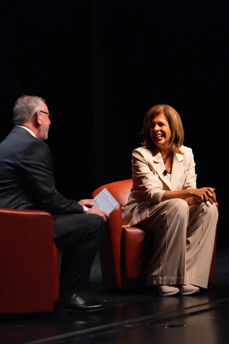 Hoda Kotb on stage during a panel at Virginia Tech, seated for a live conversation.