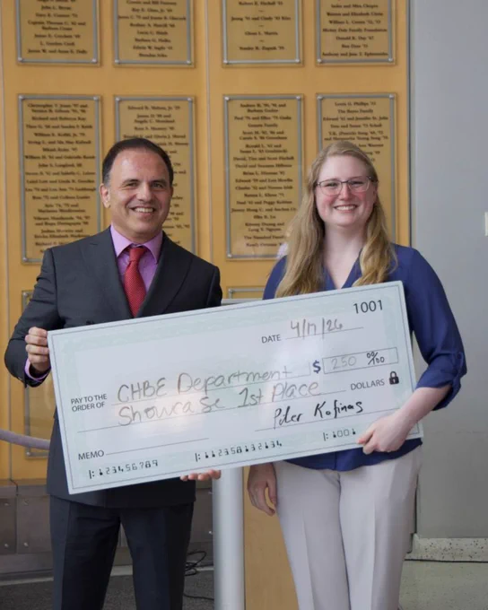 Photo of Chair Peter Kofinas (left) and Alyssa Peterson (right) holding a a huge check 
