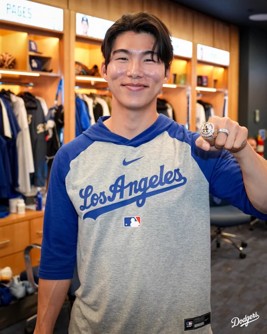 A photo of Hyeseong Kim posing for a photo with his World Series ring.