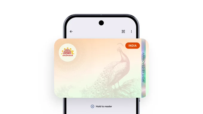 An illustration of a smartphone displaying a digital Aadhaar card. The card design is centered on the screen and features a light orange and white background with a faint illustration of a peacock. 
