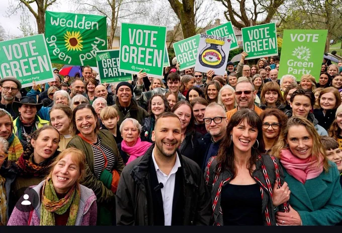 Group of people smiling at the rally.