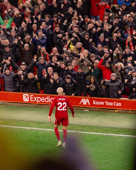 Hugo Ekitike celebrating with Liverpool fans at Anfield.