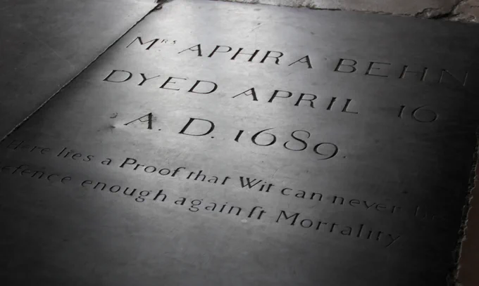 Inscribed stone floor memorial for Mrs. Aphra Behn, dated April 16, 1689. The engraving mentions, “Here lies a Proof that Wit can never be defence enough against Mortality.” The text is carved in elegant, historical lettering, creating a solemn atmosphere.