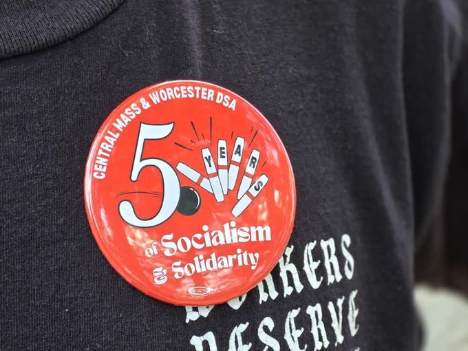 A five-year anniversary button that says “Central Mass & Worcester DSA” and “5 years of socialism and solidarity” with an image of a small ball hitting candlepins
