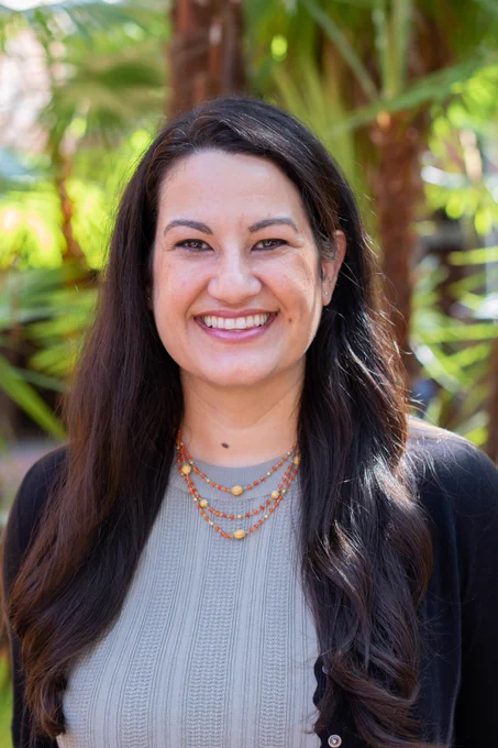 Headshot of Melissa Soto, Ph.D., with greenery behind her.