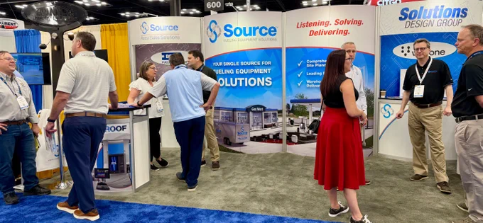 Photo of people visiting the Source booth, 826, during the M-PACT Fuel & Convenience Tradeshow.