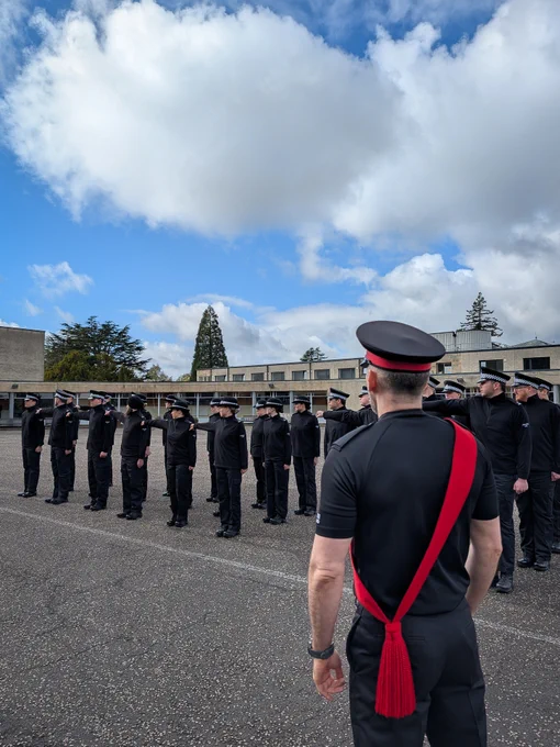Police officers standing on the parade square during a drill lesson.