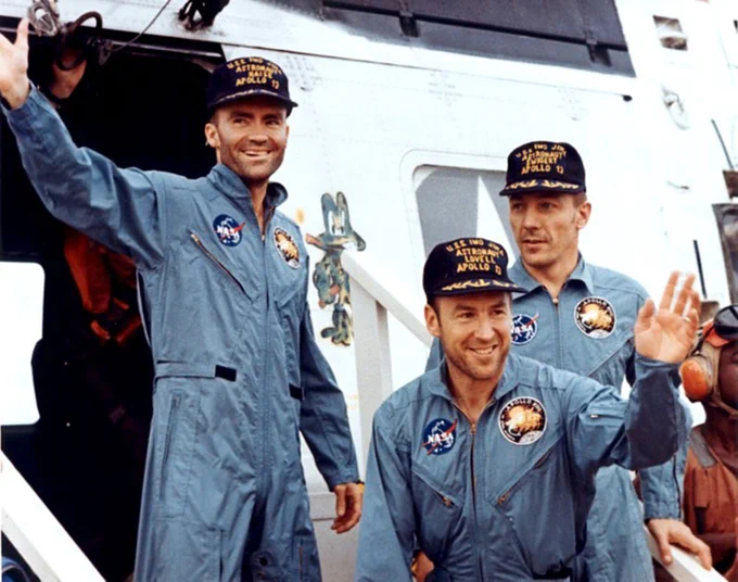 The crewmembers of the Apollo 13 mission, step aboard the USS Iwo Jima, prime recovery ship for the mission, following splashdown and recovery operations in the South Pacific Ocean. Exiting the helicopter which made the pick-up some four miles from the Iwo Jima are (from left) astronauts Fred W. Haise Jr., lunar module pilot; James A. Lovell Jr., commander; and John L. Swigert Jr., command module pilot. The crippled Apollo 13 spacecraft splashed down at 1:07:44 p.m. (EST), April 17, 1970.