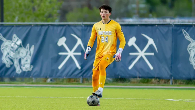 #24 Zach MacDonald stands with his foot on the ball outside the box and surveys the field during a match against Harpos FC on April 15, 2026
