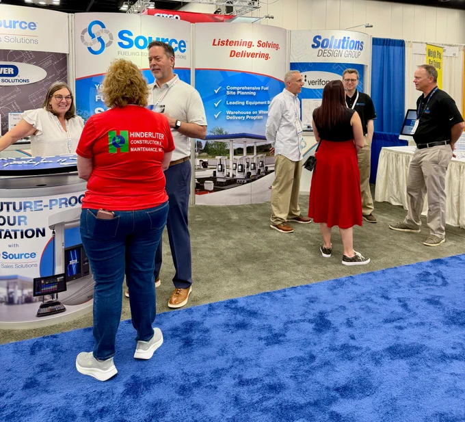 Photo of people visiting the Source booth, 826, during the M-PACT Fuel & Convenience Tradeshow.